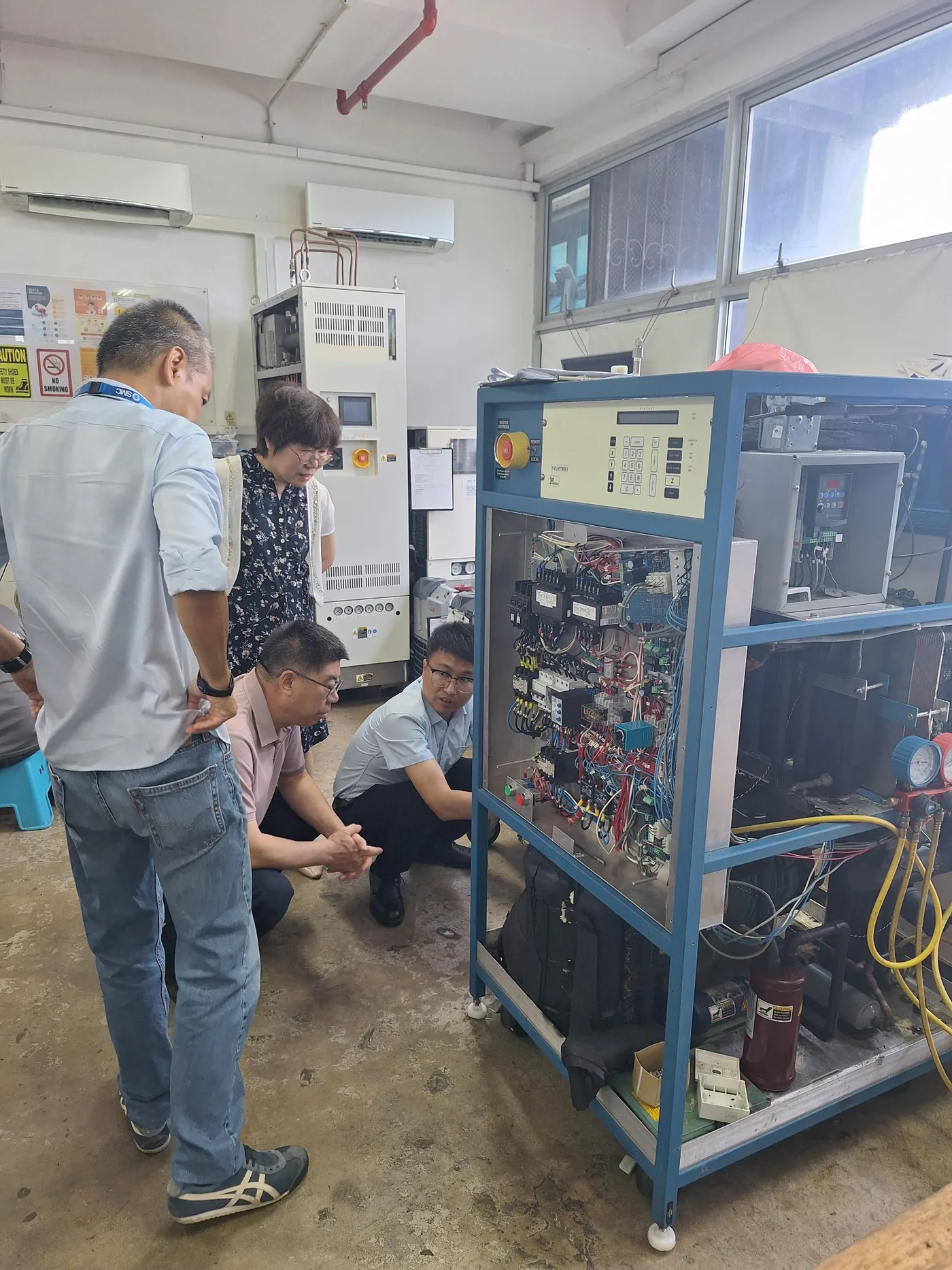 Polytroniks and WIIP engineers reviewing an industrial chiller